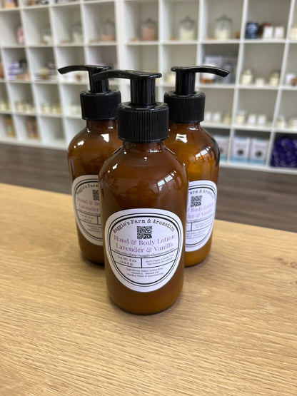 Four amber face and body lotion bottles on a wooden counter