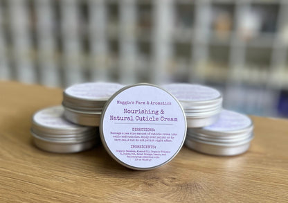 Cuticle cream tins stacked on a wooden counter