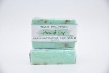 Eucalyptus and peppermint goat's milk bar soap in green packaging, shown stacked