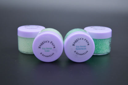 Four green sugar lip scrub jars with purple lids