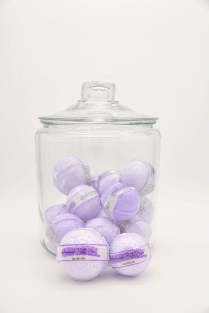 Purple Lavender bath bombs arranged in and around a glass jar