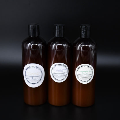 Vanilla, Lavender, and Tea Tree body wash bottles on a dark background