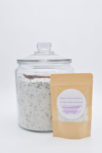 Lavender botanical bath salts in a pouch beside a large glass jar