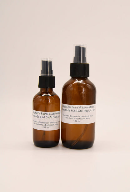 Two amber outdoor spray bottles on a light background
