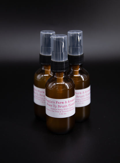 Three amber makeup brush cleaner spray bottles