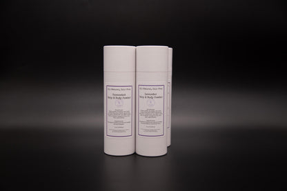 Two white body powder containers on a dark surface