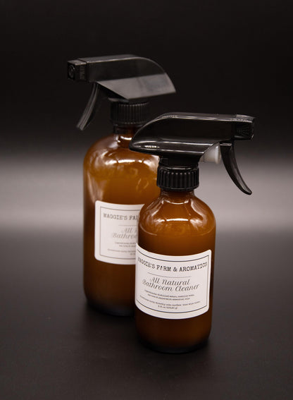Large and small bathroom cleaner spray bottles viewed at an angle