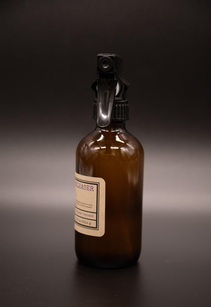 Angled view of an amber wrinkle releaser spray bottle