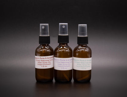 Three amber Oh Crap bathroom spray bottles