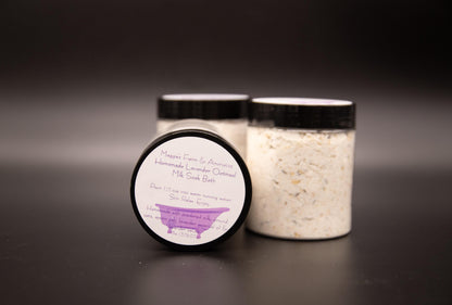 Three Lavender Oatmeal milk bath soak jars on a dark surface