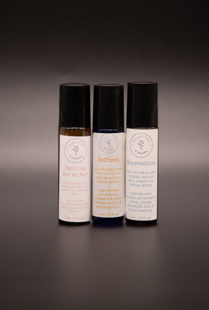 Close view of three essential oil roller blend bottles