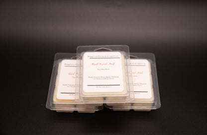Three Red Kool-Aid soy wax melt packages on a dark background
