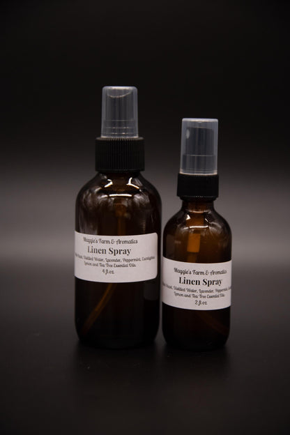 Two sizes of amber linen spray standing side by side