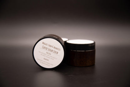 Two jars of coffee sugar scrub with one labeled lid facing forward