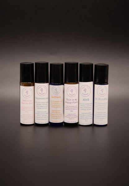 Close view of six assorted essential oil roller blend bottles