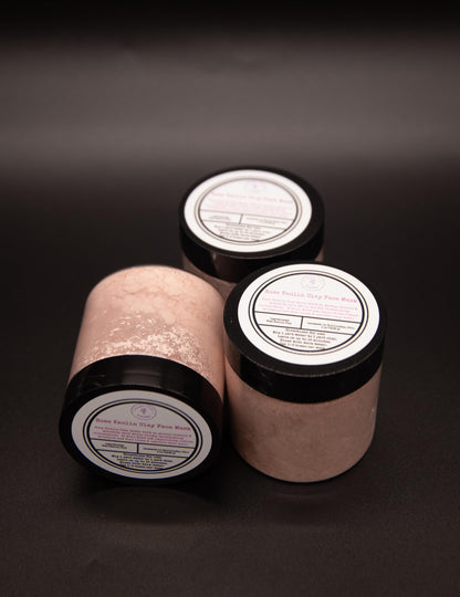 Four Rose Clay face mask jars arranged on a dark surface