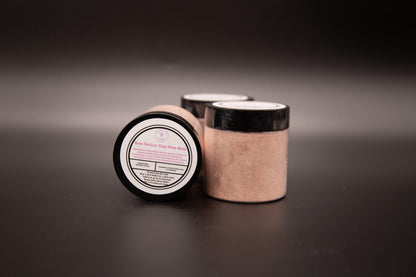 Three Rose Clay face mask jars on a dark surface