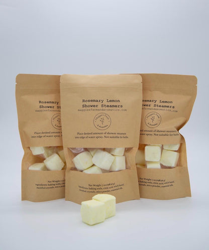 Three Rosemary Lemon Shower Steamers packages with pale-yellow cubes