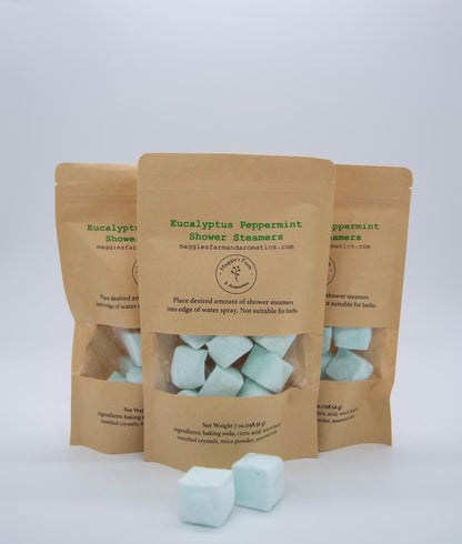 Three Eucalyptus & Peppermint Shower Steamers packages with mint-green cubes