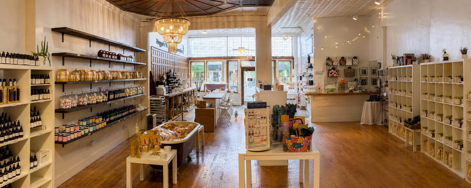 Interior of Maggie's Farm and Aromatics shop with handmade candles, bath goods, home fragrance, and apothecary shelves.